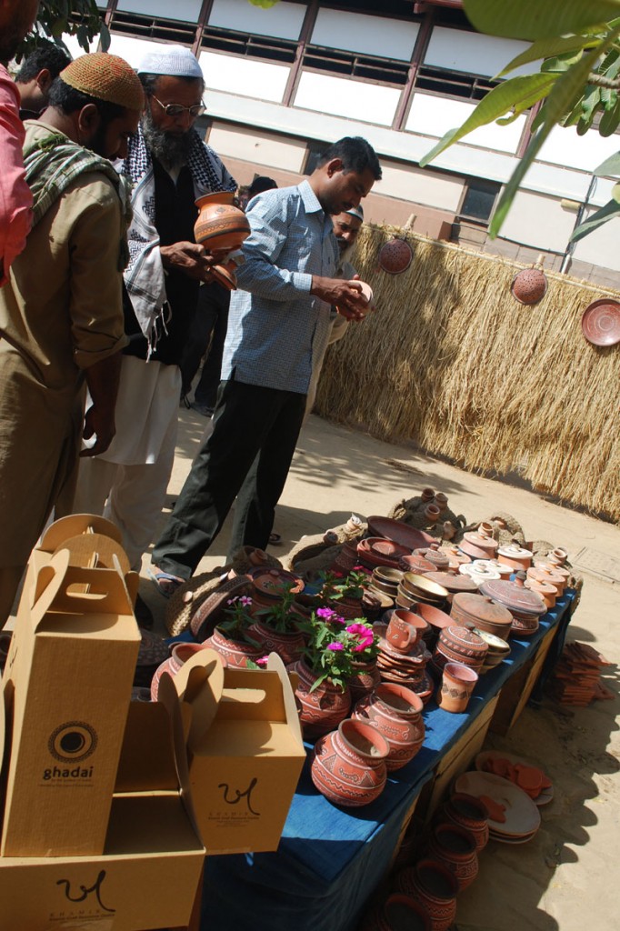Potters of Kutch keenly observe the work on display at the Bazaar, Khamir - Kutch