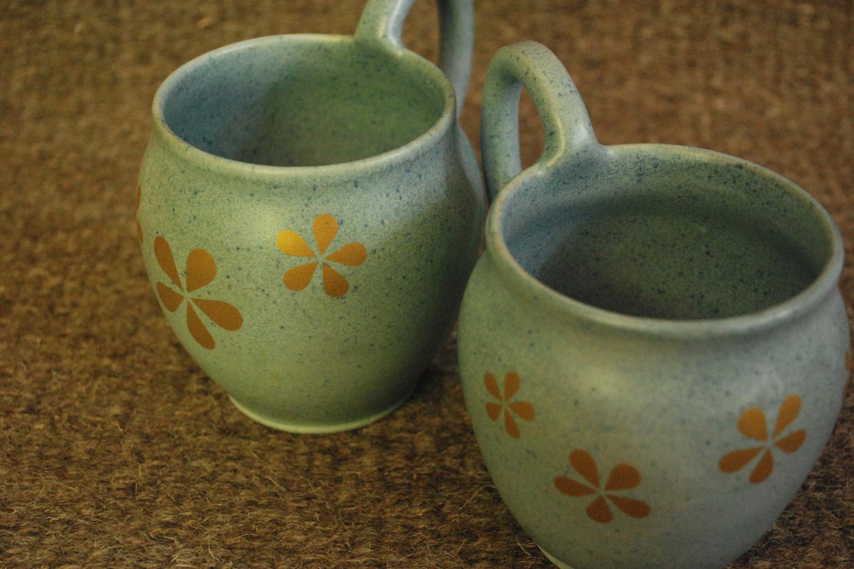 Blue handmade mugs embellished in gold